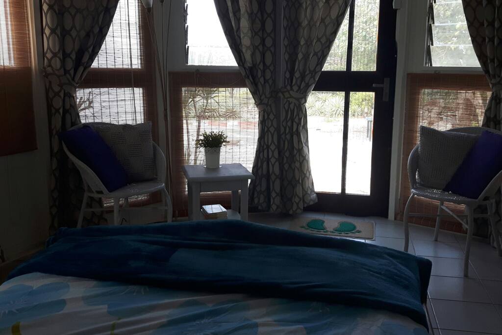 vieuw from the bed outside in the tropical garden and towards the caribbean sea