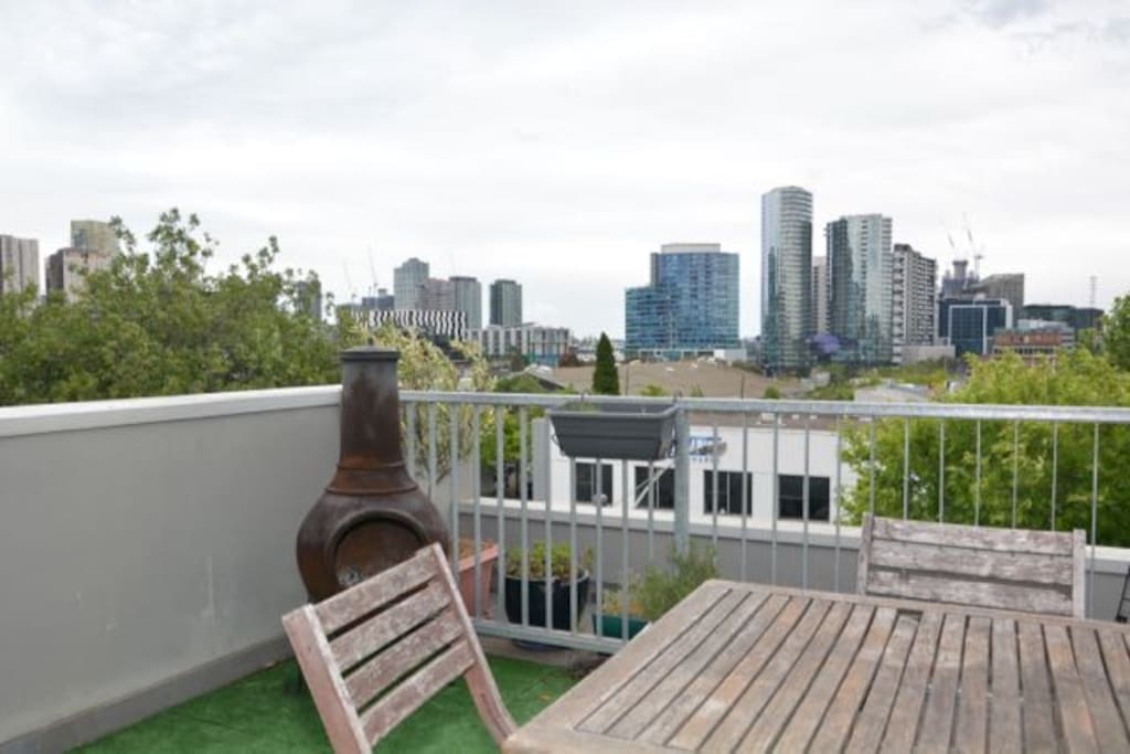 The spacious rooftop terrace has views over the city and Docklands