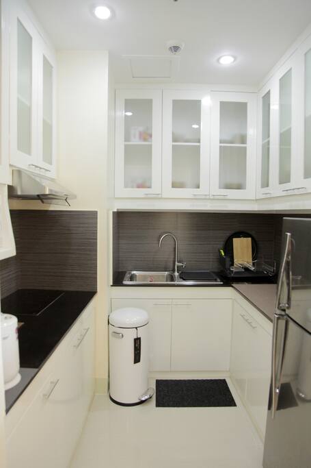 The kitchen area. You can cook using induction stove and heat food using the microwave oven. Unit comes with a refrigerator also.