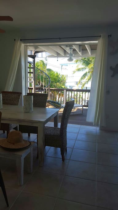 Wide windows open to balconies . Indoor / outdoor are