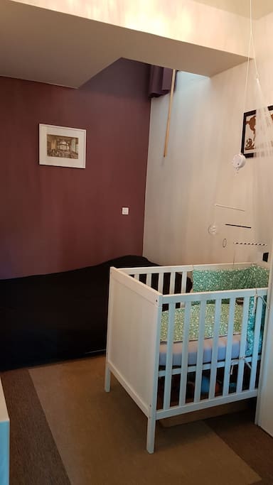 Bedroom with a double bed and a baby bed