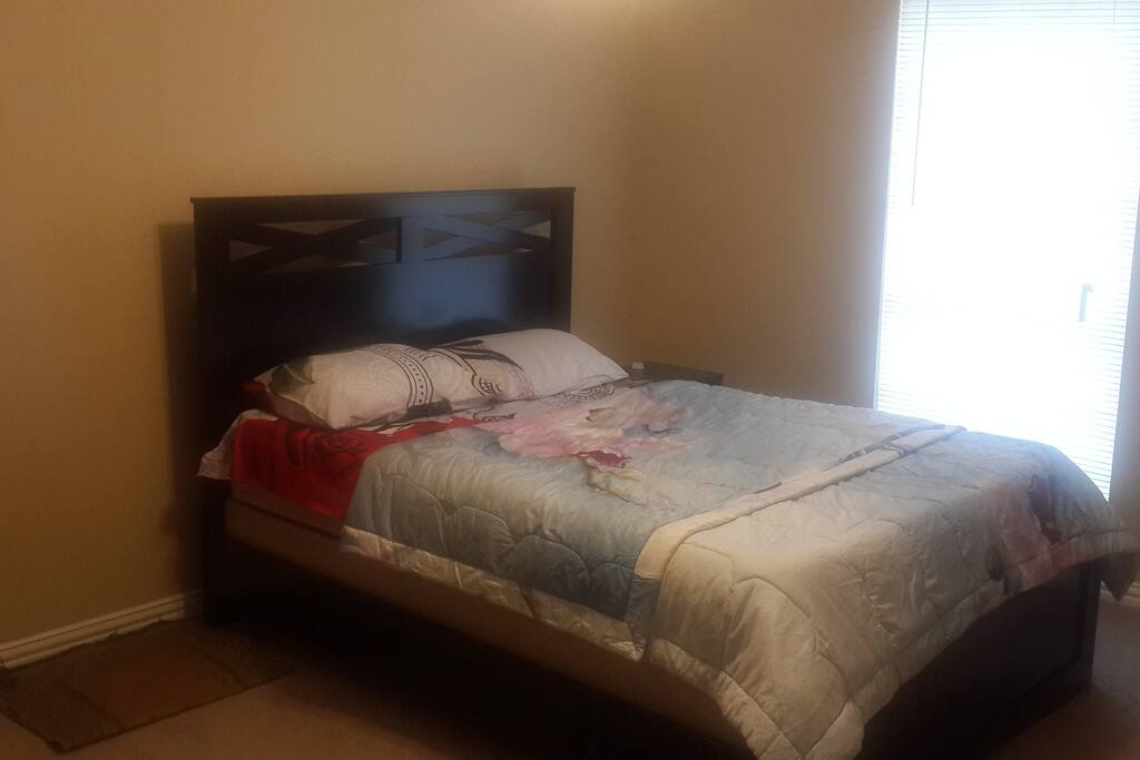 Queen sized bed with 2 pillows.