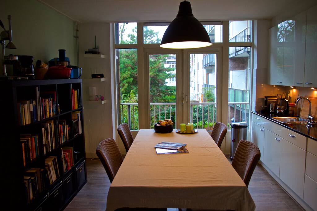 Kitchen table with view on the inner garden and access to the balcony