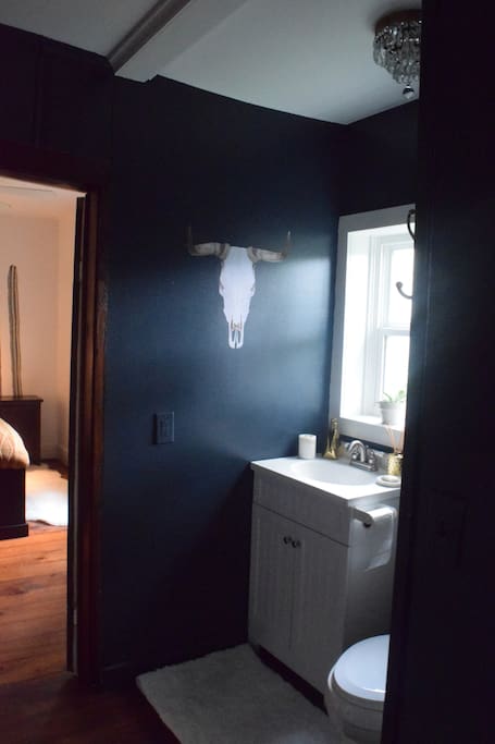 Bathroom divides kitchen from bedroom.