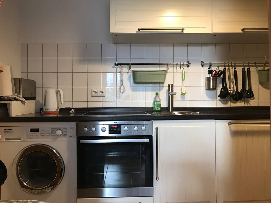 Well equipped kitchen with modern induction oven, dish washer and washer dryer combo