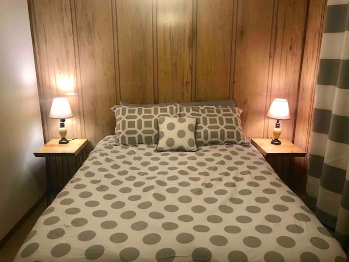 Bedroom with queen bed, closet, ceiling fan, cable TV and live edge end tables made by your Super Host! 