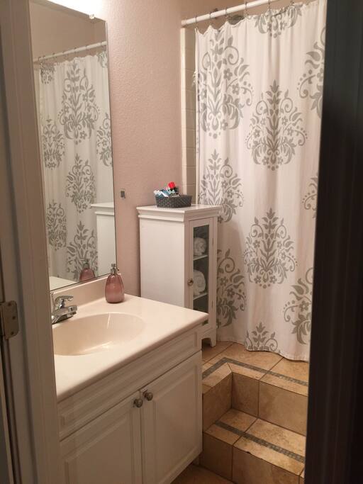 Private bathroom, stairs lead to tub/shower.