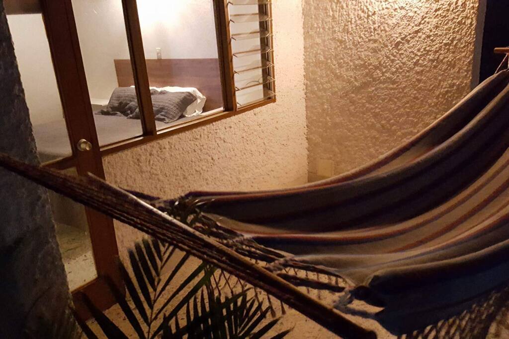 This room includes a semi-privet balcony with a hammock and sitting area.