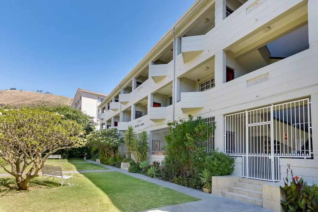 Building, front gardens and high security gate