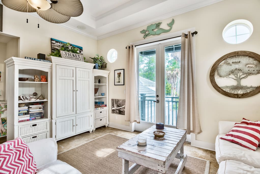 Living area with sleeper sofa/television/board games & french doors to enjoy the beautiful 30A breezes