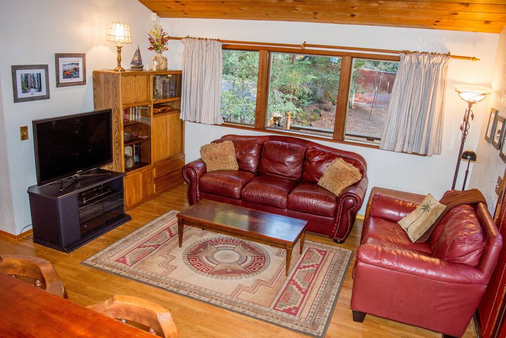 Living room has a queen size sleeper sofa. 46" Dish TV, DVD/VHS/Sirius radio.