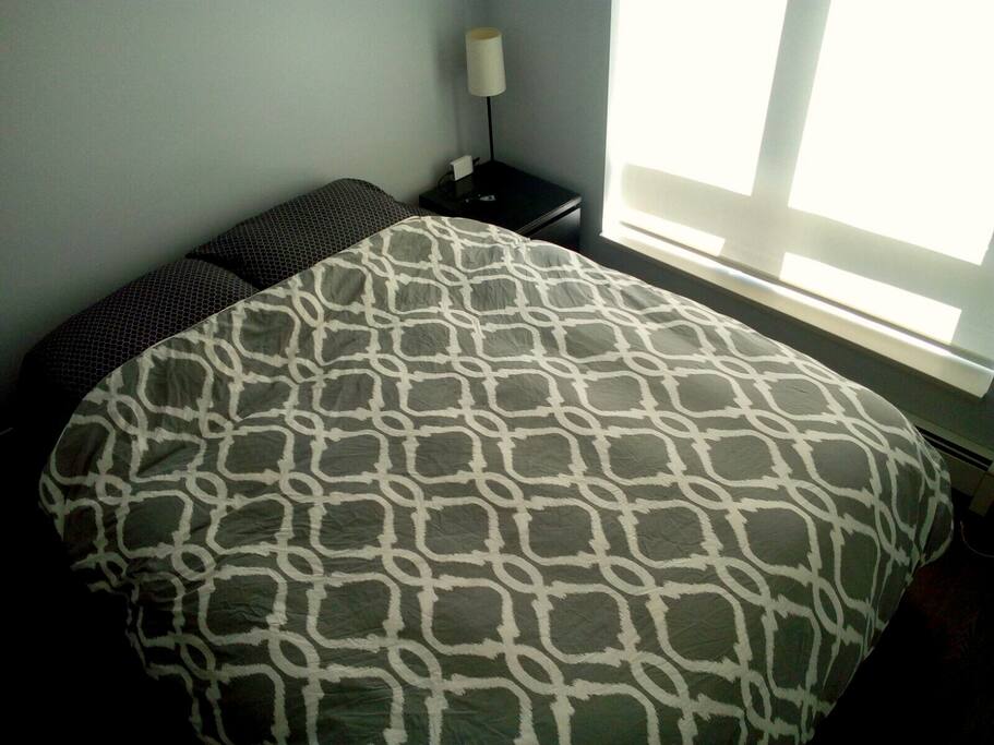 Bedroom with down duvet and large windows