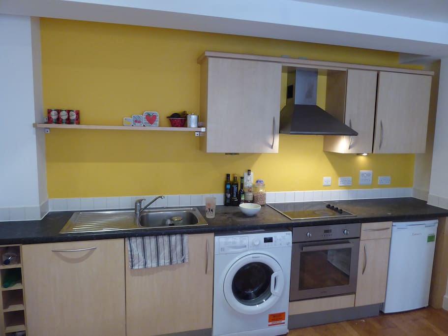 Modern kitchen to cook in, with fridge, freezer, dishwasher and washing machine.