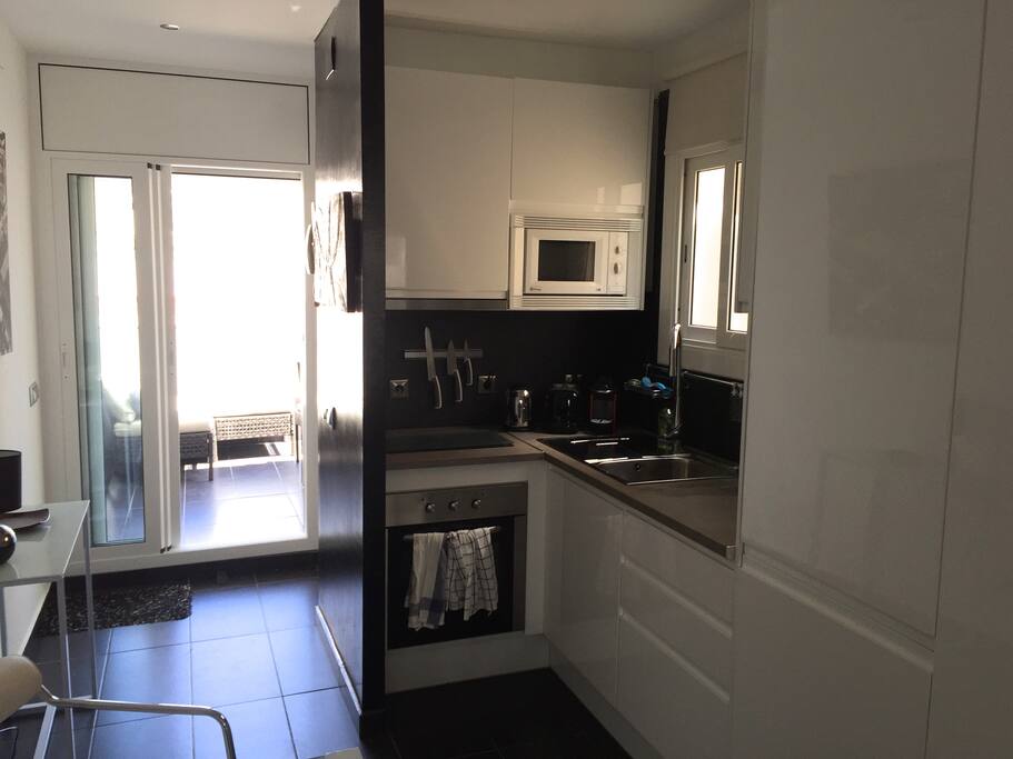 Modern fitted kitchen, with oven, induction hob and microwave.