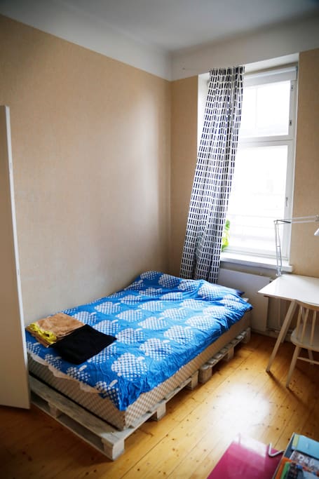 Your bed. There is an extra bed, an air mattress, a normal foam mattress and a sofa too in your room.