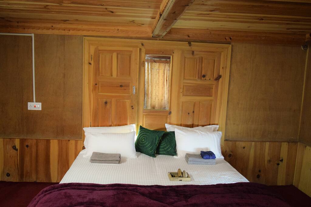 The room features closets and large windows overlooking panoramic mountain views.
