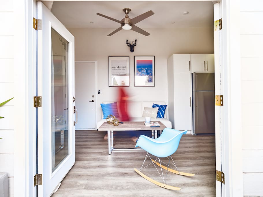 Photo was taken from the yard with the French doors open looking into living area. Ceiling fan in the living area and the bedroom.
