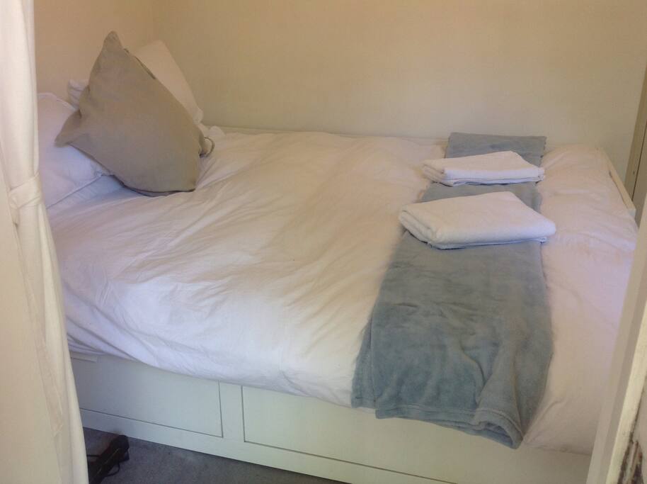 The queen-sized bed in the small and cosy basement double