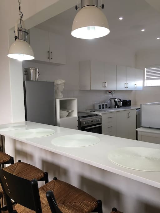 Kitchen with gas stove, dishwasher, microwave and coffee machine