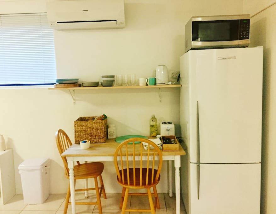 Kitchen area, fridge microwave, breakfast supplies and crockery