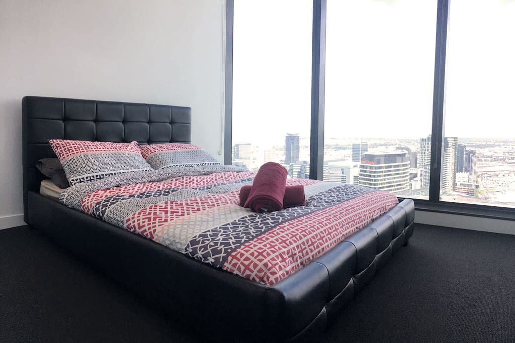 A master bedroom with a queen sized bed & a beautiful view.