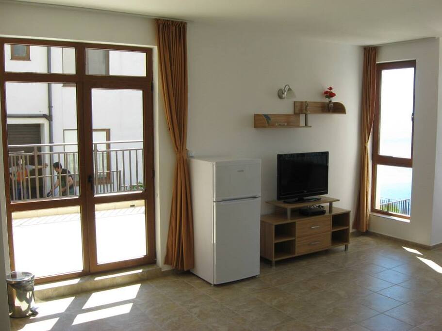 Living room with sea views, a kitchenette and a sofa bed. Satelite TV and wireless Internet