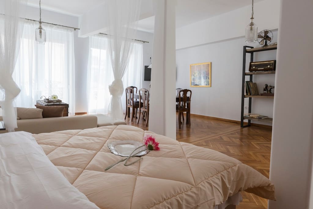 Very large living room with lounge, dining room and cleverly fashioned bedroom space.