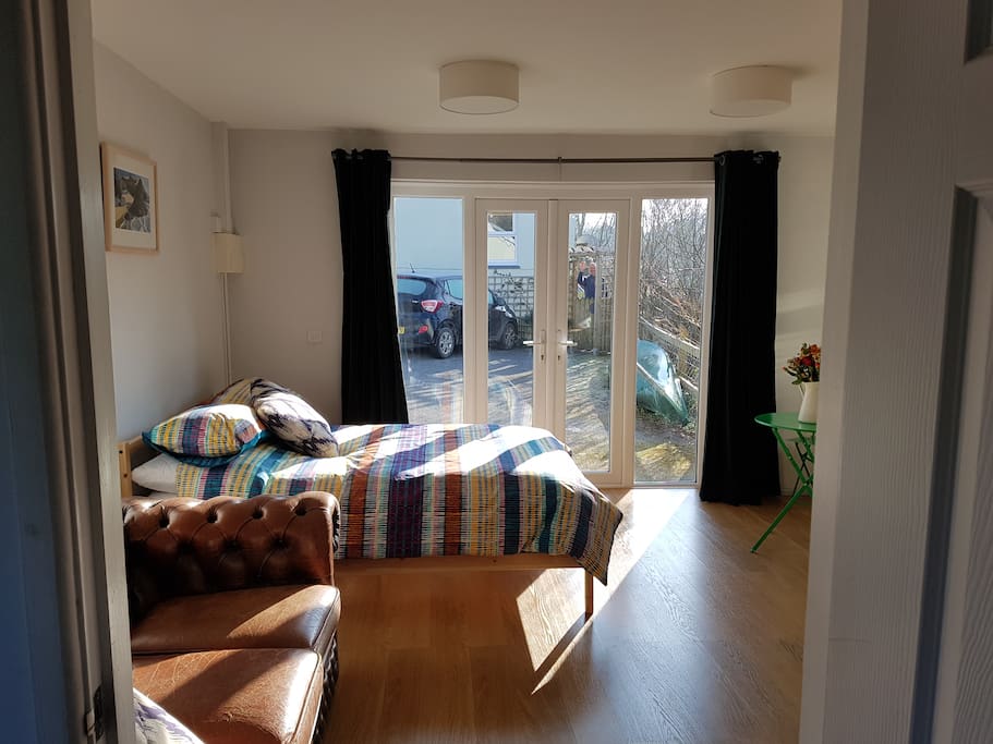 Patio doors, thick, warm curtains for privacy. Ian waving at the gate to the main house.