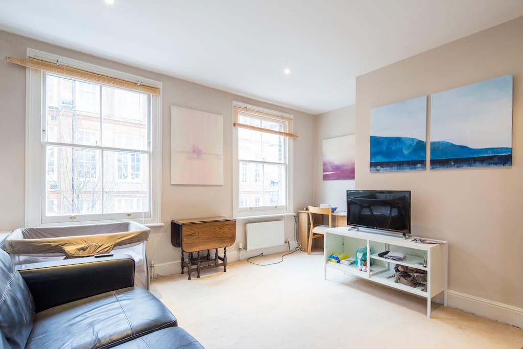 The heart of the home - another angle of the living room with comfy sofa opposite flat screen TV - a space to relax after a day out in London!
