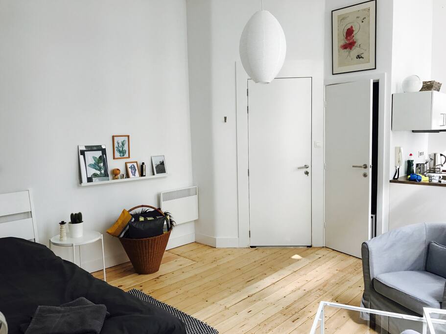 Living space, open kitchen, door to bathroom