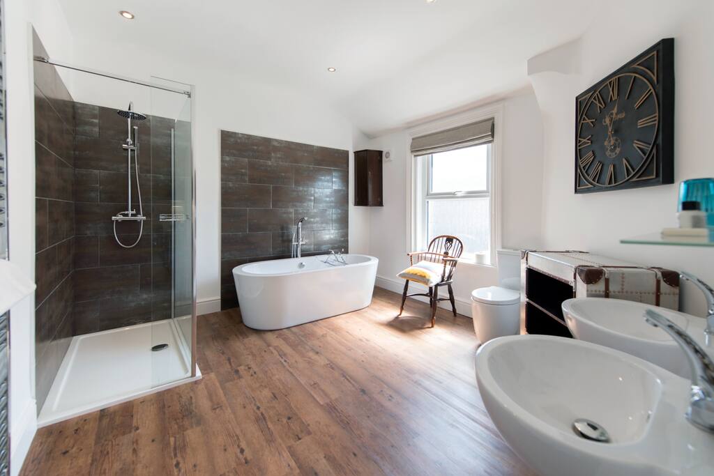 Beautifully appointed, spacious bathroom with free standing bath, double shower and two sinks.
