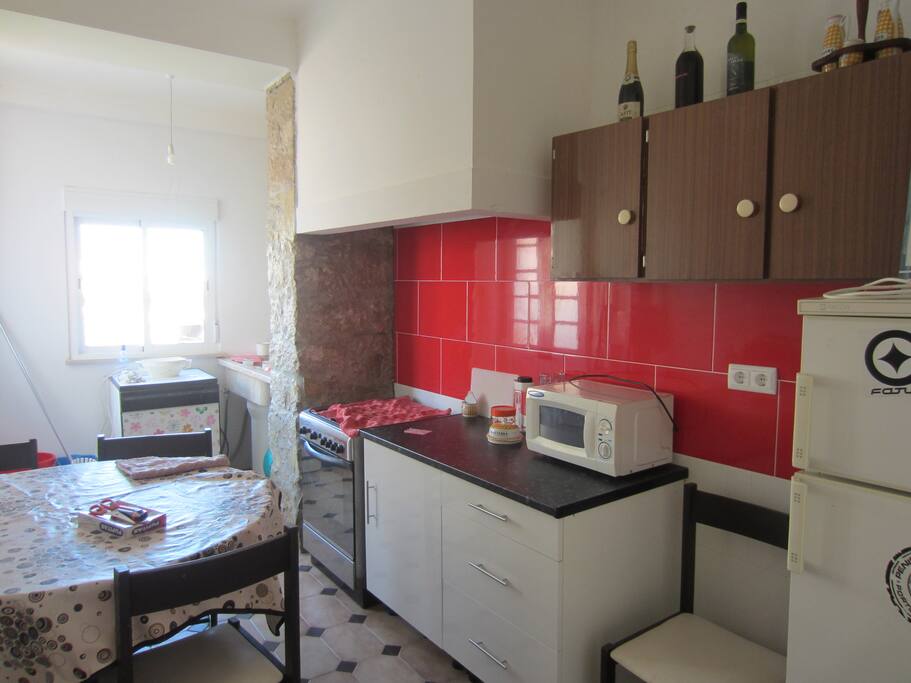 kitchen, with table and eats for meals