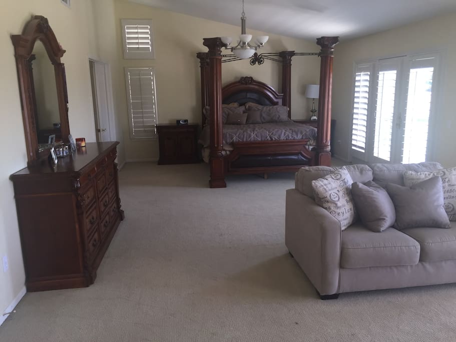 Master Bedroom with Love Seat and 70 inch HDTV