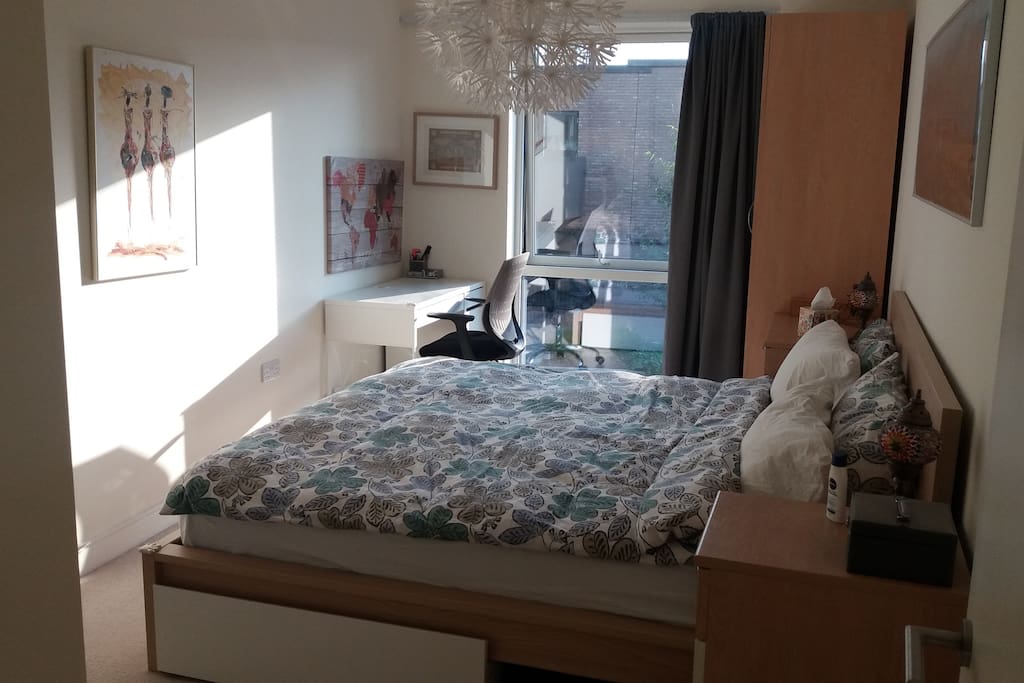 Bedroom with large bed and blackout curtains