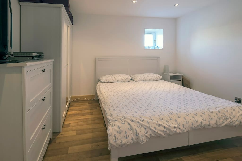 Bright double bedroom with space for a single blow-up mattress on the floor for a third person if necessary.