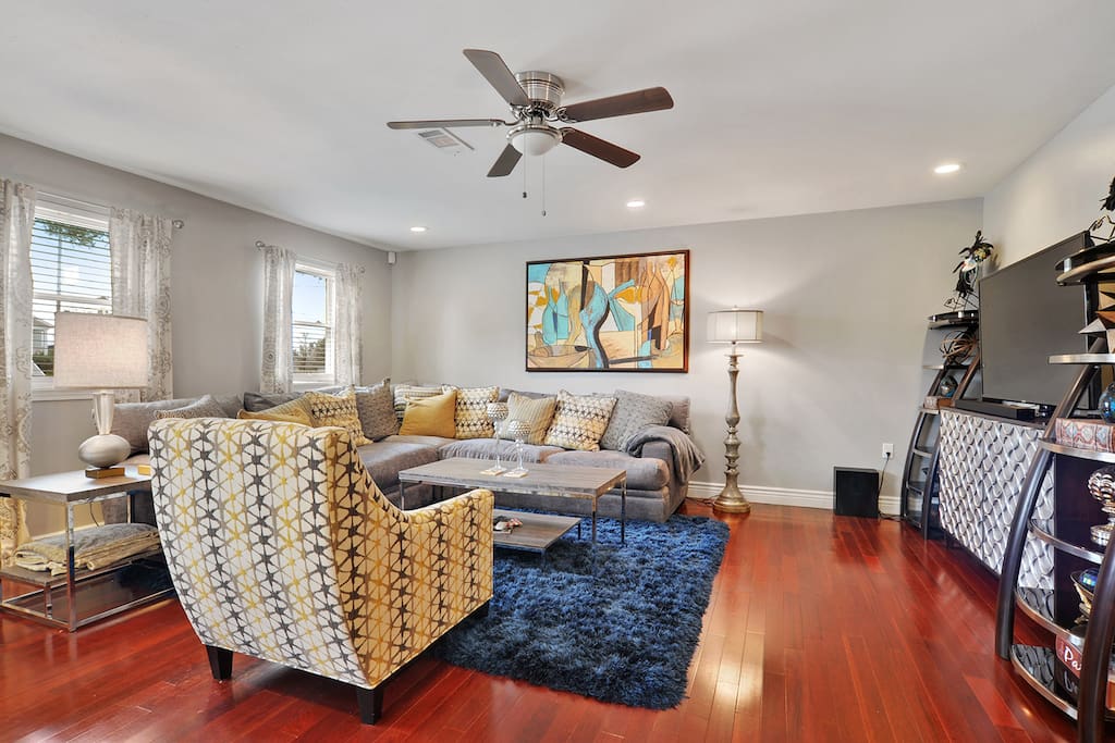 Beautifully appointed family room. Large screen television. Lots of light through windows.