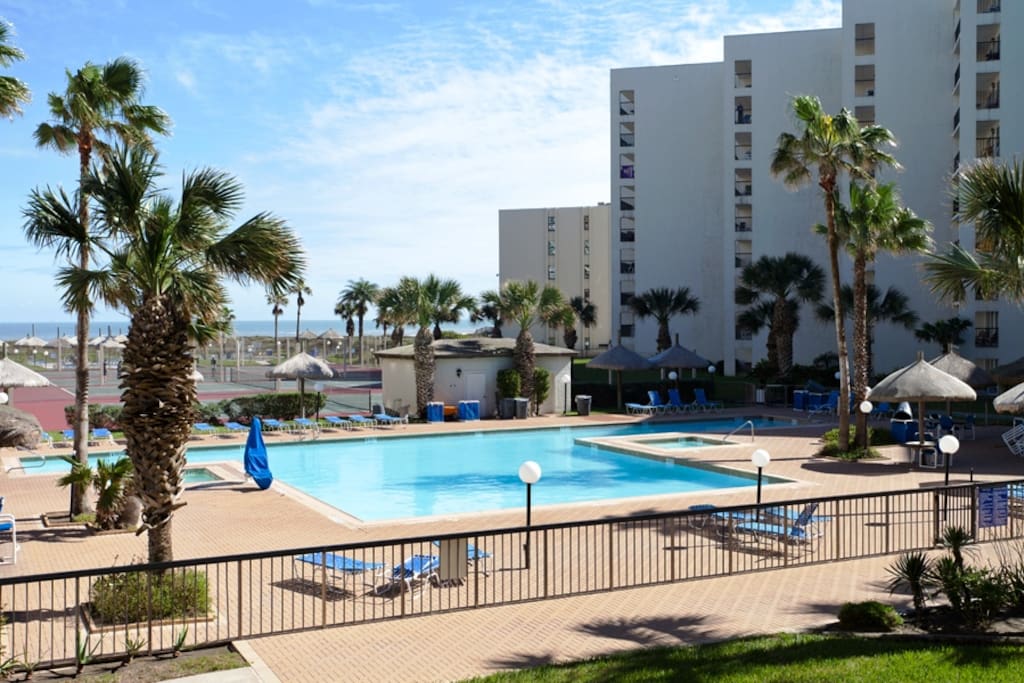 View from our private balcony of the large pool, poolside bar, tennis courts and beach