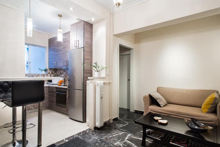 ห้องนั่งเล่นและห้องครัว: เฟอร์นิเจอร์ที่สะดวกสบายและหินอ่อนสีดำและสีขาว