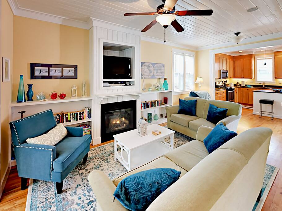 The main living area features a natural gas fireplace surrounded by 2 sofas and a cozy accent chair.