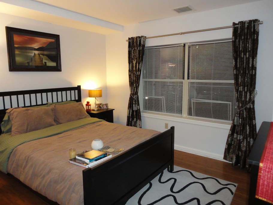 Guest bedroom with queen bed, dresser and closet