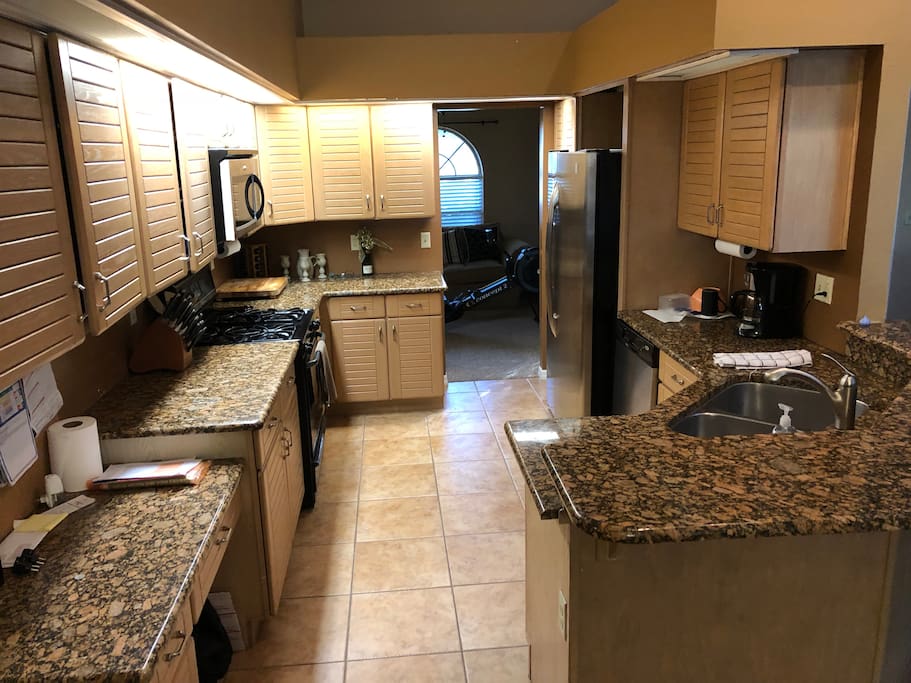 Kitchen with gas stove and full size fridge.