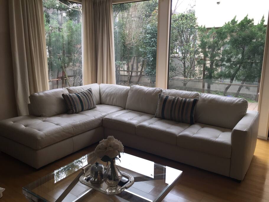 Light filled living room overlooking private courtyard with BBQ