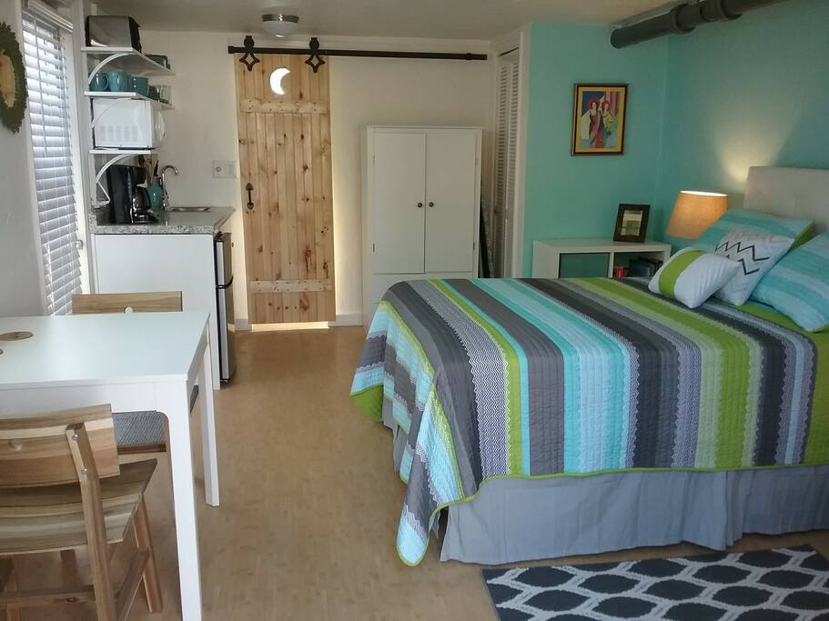 The bathroom has a custom-mad sliding barn door