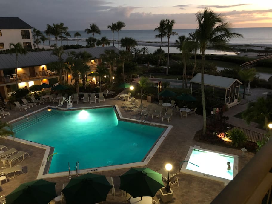 Night shot view of resort pool & hot tub with Gulf in background
