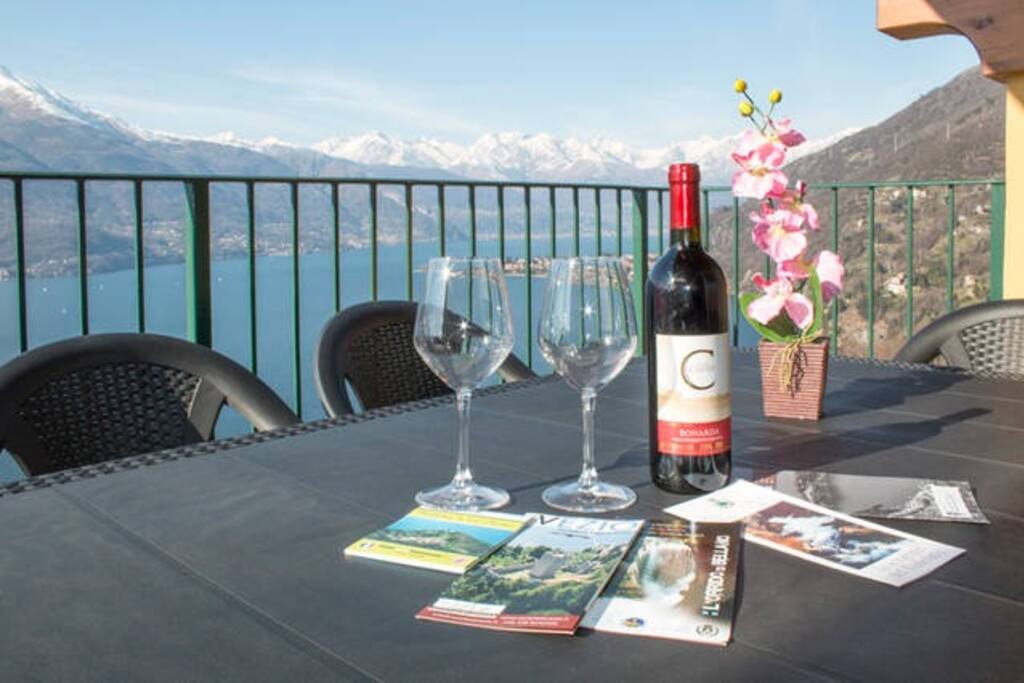 terrace with lake view, table with six chairs for unforgettable lunches, chairs, tent for shade