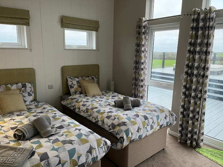The second bedroom has full-size twin beds and also has an en-suite shower room