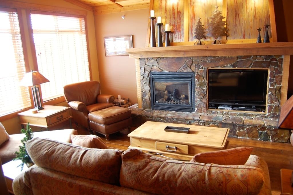Cozy up by the fireplace and TV enclosed in stylish stone framing