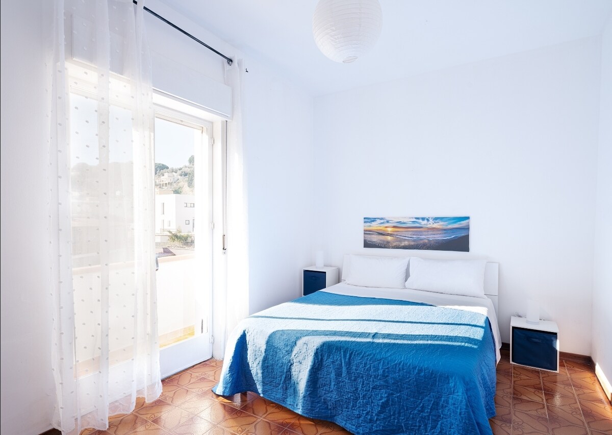Elegante dormitorio doble con vistas a un balcón privado, ideal para disfrutar de la luz de la mañana o de una agradable brisa nocturna. Equipado con un ventilador, garantiza un ambiente fresco y relajante para un descanso regenerador.