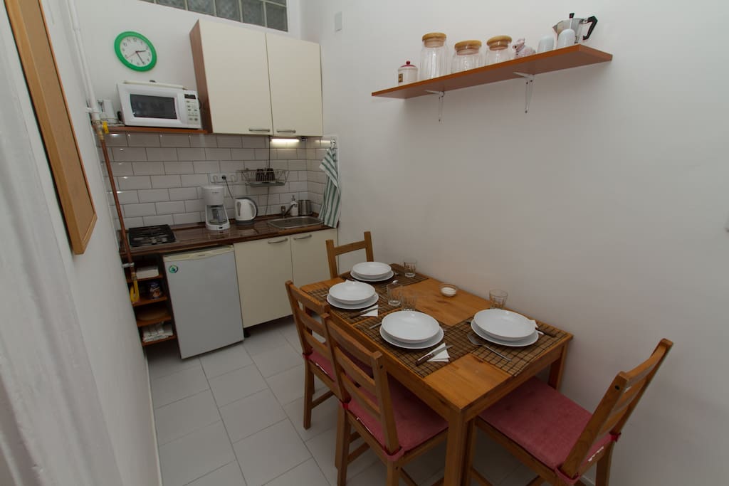 Kitchen large enough for four people to sit down for a meal.