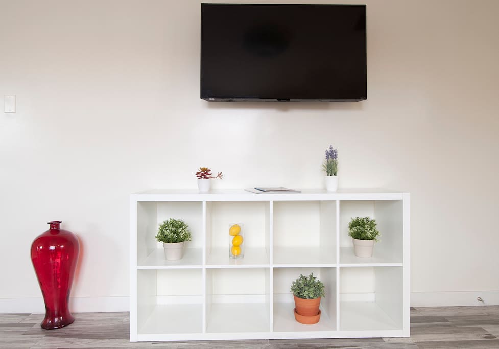 Flat screen wall mounted smart TV with Netflix and Hulu when you feel like relaxing at home.